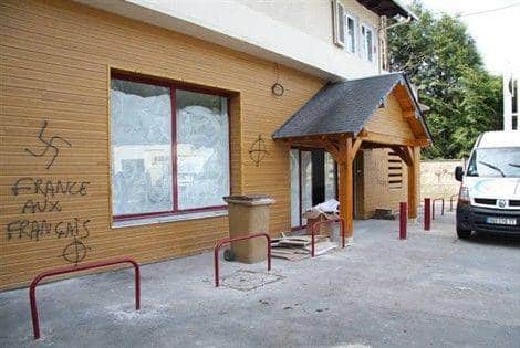 a halal (religious Islamic bakery) in Lisieux, France with Islamic hatred slogans and a Nazi swastika painted on the wall